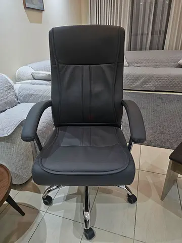 Black ergonomic office chair with armrests and caster wheels