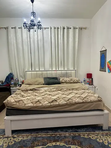White wooden king-size bed frame with slatted headboard
