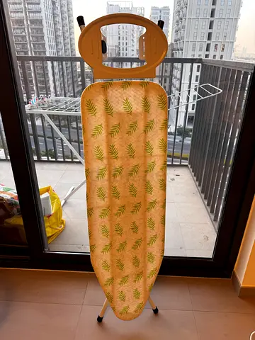 Used ironing board with cover — good condition