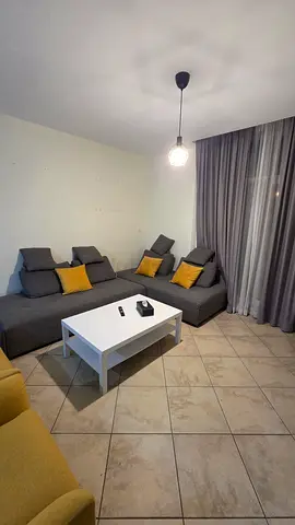 Gray L-shaped Sofa with Cushions and White Coffee Table - Good Condition