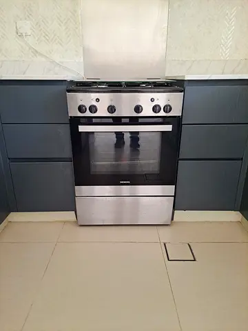 Used freestanding gas/electric oven with multiple racks - good working condition