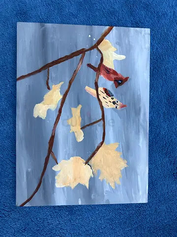 2 birdies siting on a tree
