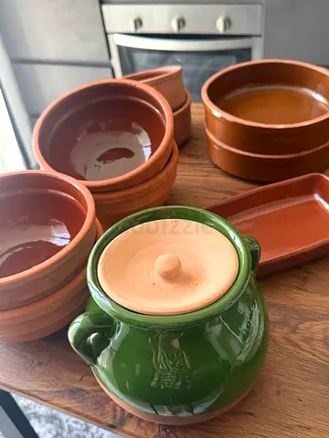 Set of terracotta and ceramic kitchen serving bowls and dishes