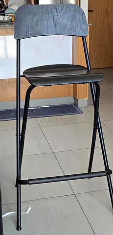 Black metal bar stool with wooden back — good used condition