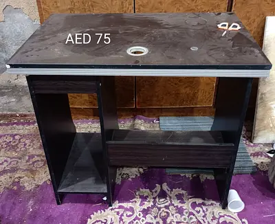 Compact dark wood computer desk with cable hole - AED 75