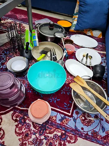 Mixed kitchen cookware and utensils set - pots, pans, bowls, plates, and tools