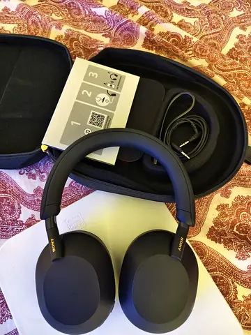Sony WH-1000XM5-style Over-Ear Noise Cancelling Headphones with Case and Cables.