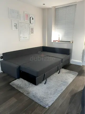 Dark grey L-shaped sofa bed with storage - excellent condition