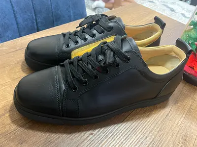Christian Louboutin Louis Junior low-top sneakers in a striking black and gold colorway