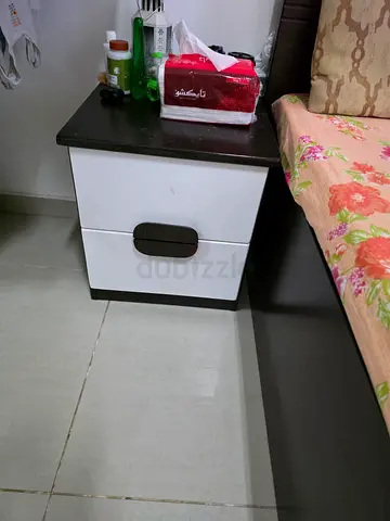 Small two-drawer bedside table in white and dark wood