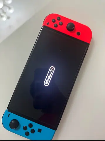 Nintendo Switch OLED with Red  Blue Joy‑Con with Games, Controller, Screen Protector and SD Card