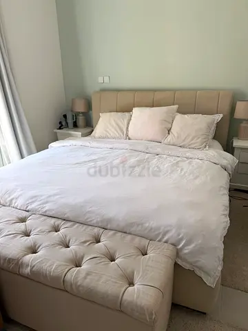 Comfortable beige upholstered bed