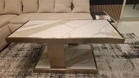 Modern marble-top coffee table with metal base for use inside and outside apartment