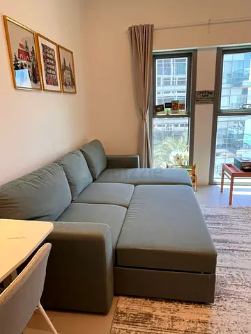 IKEA L-shaped convertible sofa bed in grey-green — perfect condition