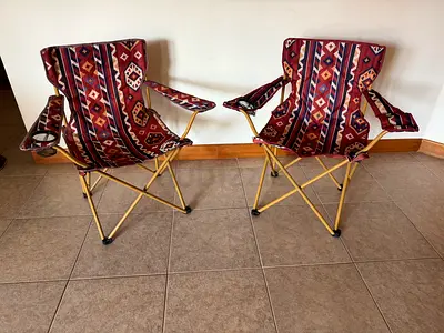 2 folding camping chairs with colorful covers