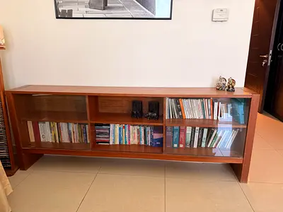 Long wooden low bookcase with glass doors - good condition