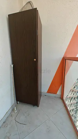 Tall single-door wardrobe / storage cabinet in dark wood finish