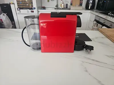 Red nespresso Essenza coffee machine