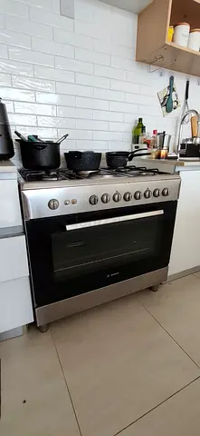 Used Bosch gas and electric stove with 6 burners and stainless steel oven - in good condition.