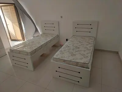 Pair of single white wooden beds with mattresses - good condition