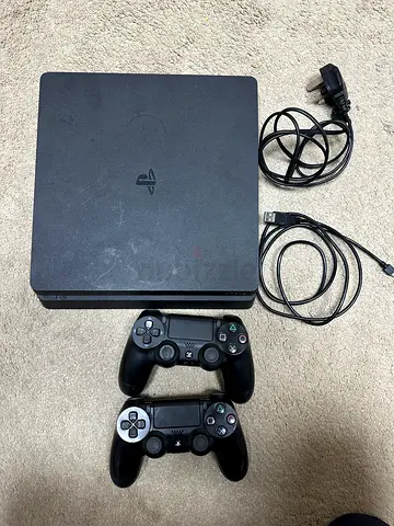 PlayStation 4 Slim with 2 Controllers and Cables - Good Working Condition 1TB it has 5 games in it