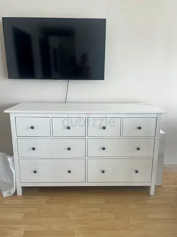 White wooden cabinet with multiple drawers