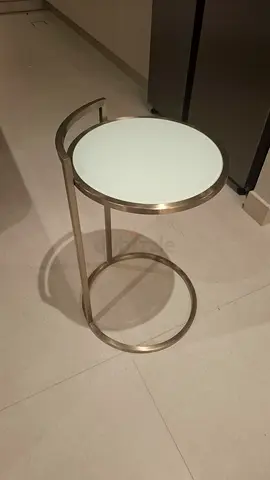 Small round glass-top side table with gold metal frame