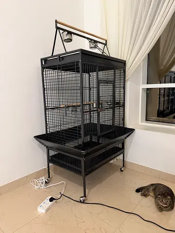 Large metal bird cage on stand with wheels — good condition