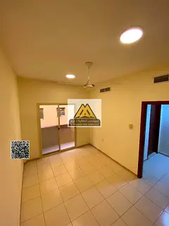 1BR apartment in Al Hamidiya 1 with balcony and central AC. AED 26K yearly, 4 payments, near Ajman U
