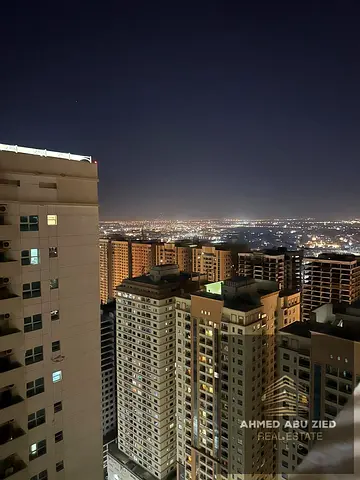 1‑bedroom apartment with hall for annual rent in Emirates City Towers, Ajman. Open panoramic view, spacious hall, closed kitchen, 2 bathrooms, balcony