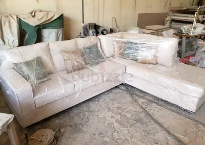 L-shaped cream fabric sectional sofa — used but good condition, opens to a queen bed with mattress.
