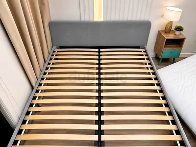 Queen-size upholstered bed frame with wooden slats — good condition