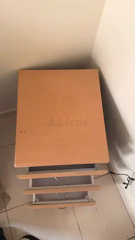 Small wooden bedside table with three drawers