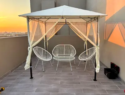 Outdoor gazebo with mosquito net and patio furniture - good condition