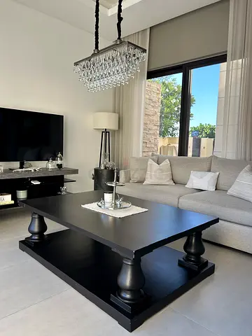 Modern black wooden coffee table with pedestal legs