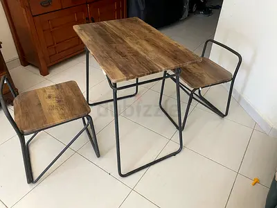 Compact industrial-style wooden table with two matching stools