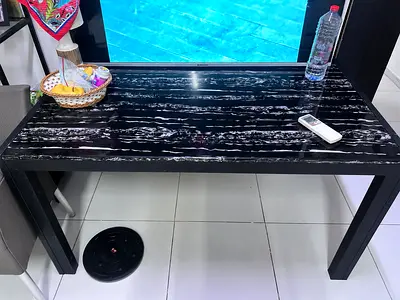 Black marble table with 2 rattan chairs
