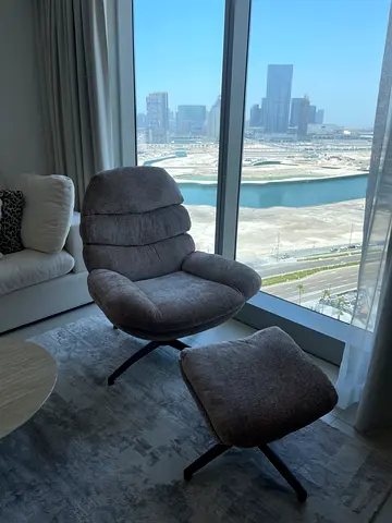 Grey upholstered lounge chair with matching ottoman - perfect condition