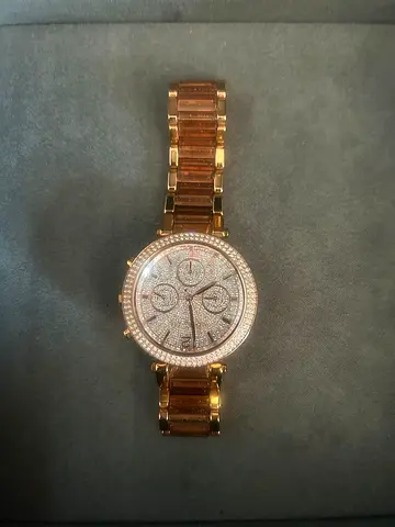 Gold-tone womens wristwatch with crystal-studded dial