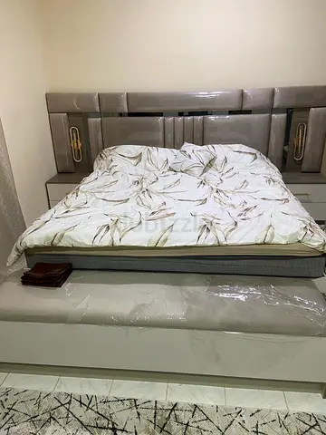 Queen size upholstered bed frame with mattress and headboard