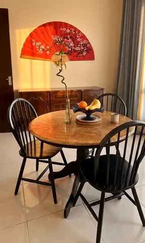 Round Wood Top Dining Table with Black Wooden Chairs