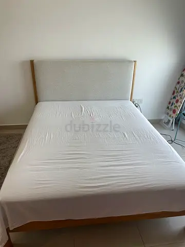 Wood frame queen bed with padded headboard – good condition