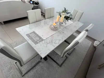 Modern white marble-look dining table with 6 upholstered chairs