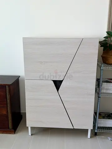 Modern Light Wood Cabinet with Geometric Door Design. Shoe storage.