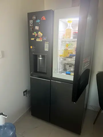 LG Side-by-Side Refrigerator with Ice  Water Dispenser - Good Condition.