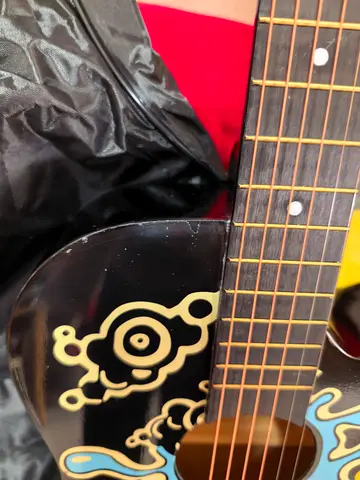 Used Black Acoustic Guitar with Decorative Design - Good Condition