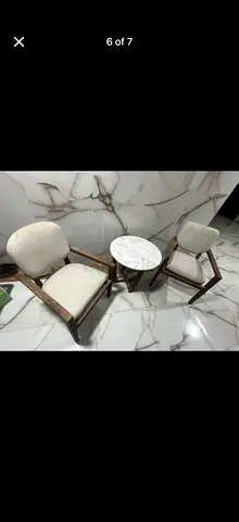 Pair of mid-century style lounge chairs with marble-top side table
