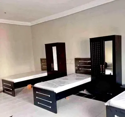 Dark wood bedroom set with twin beds and wardrobes