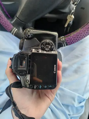 2 Canon DSLR camera body with strap and lense
