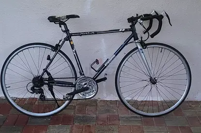 Used road bike - lightweight frame with drop bars, good working condition